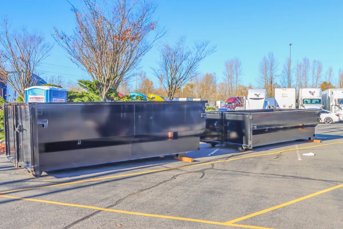 Professional dumpster rental service with roll-off container on residential driveway in Carrollton